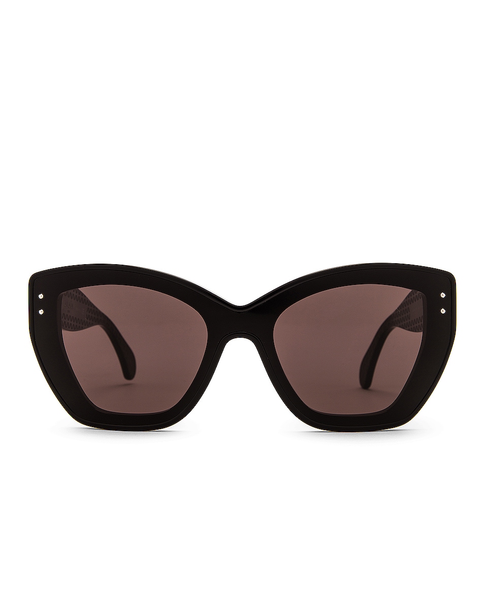 Image 1 of ALAÏA Feminine Soft Cat Eye Sunglasses in Shiny Black