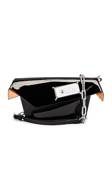 Click to view more detailed imagery on our partner's website Maison Margiela Snatched Clutch In Black