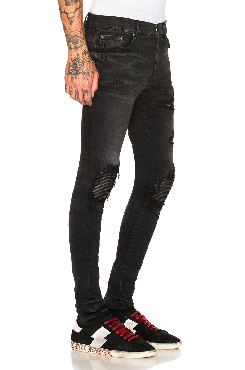 black amiri jeans with patches