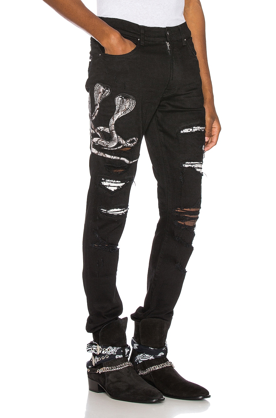 black amiri jeans with patches