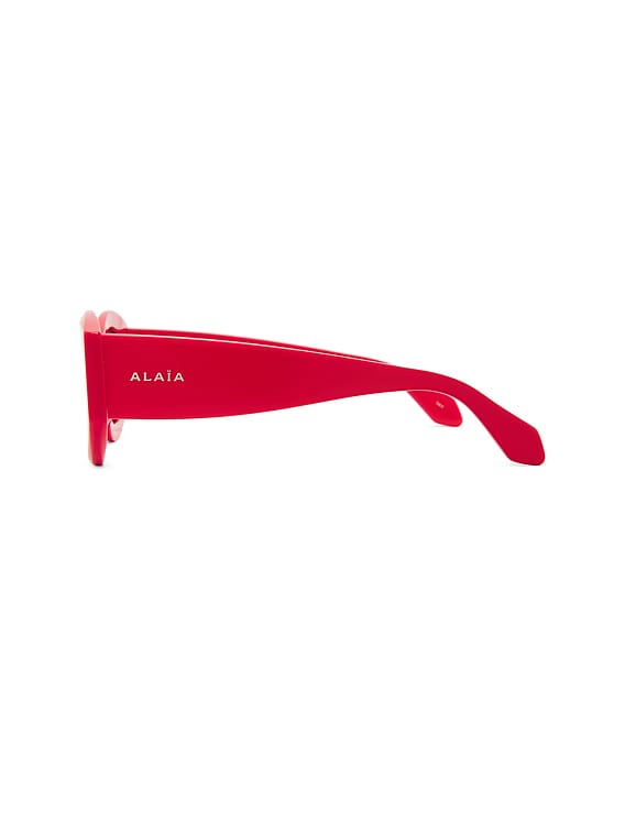 ALAÏA Oval Sunglasses in Red & Grey | FWRD