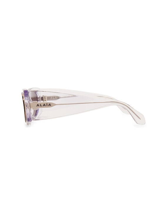 ALAÏA Oval Transparent Sunglasses in Crystal & Grey | FWRD