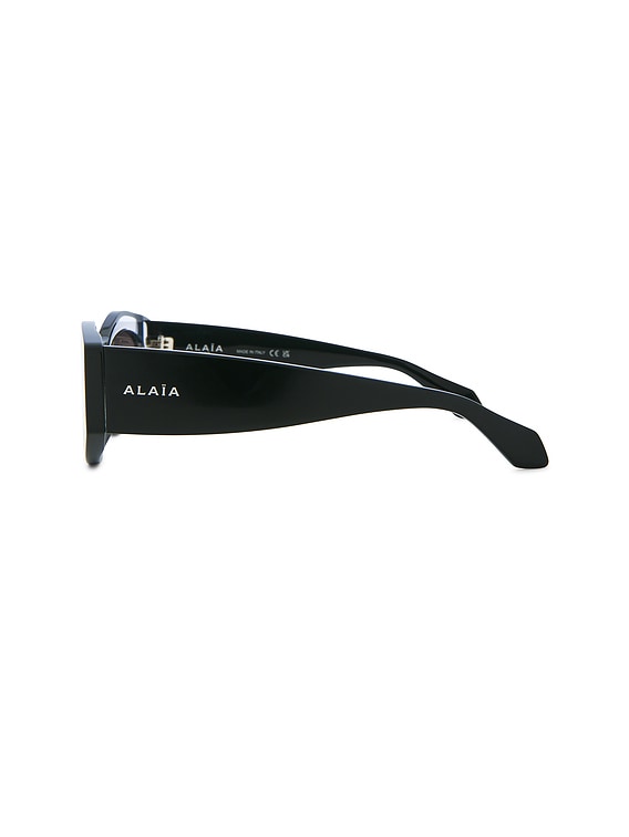 ALAÏA Oval Sunglasses in Crystal, Black, & Grey | FWRD