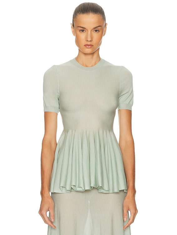 ALAÏA Peplum Top in Vert Amande | FWRD
