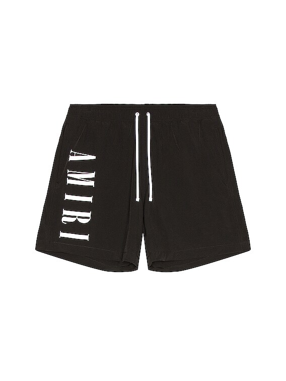 Amiri Vertical Logo Swim Trunks in Black | FWRD