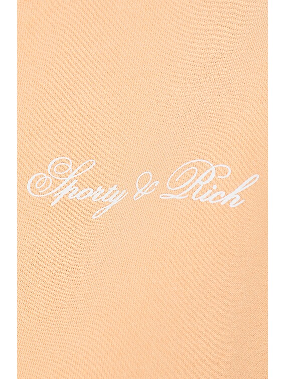 Sporty Rich Cursive Logo Cropped Crewneck Sweatshirt in Peach