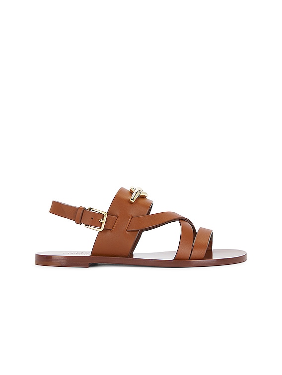 【関税込み】Valentino Garavani ブラウン VLogo Gate ミュール Valentino Garavani V Logo Gate Sandal in Tan Brown | FWRD