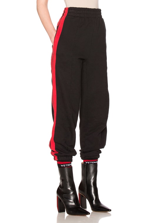 black sweatpants with red stripe