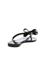Valentino Garavani Summer Rockstud PVC Bow Thong Sandal in Black, view 3, click to view large image.